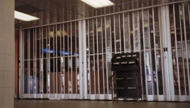 Empty retail store with security gate closed